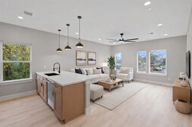 a living room with furniture a bed and a chandelier