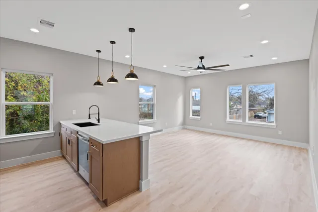 a view of a kitchen with a sink a window and stainless steel appliances