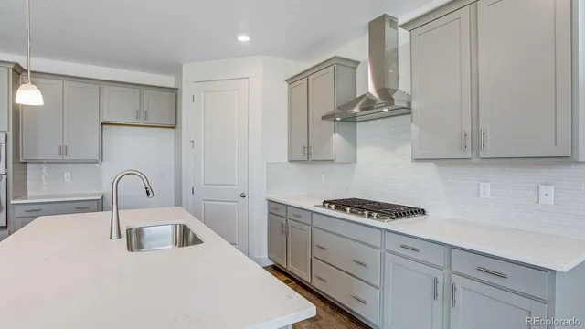 a kitchen with stainless steel appliances granite countertop a sink a stove and cabinets