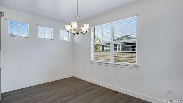 a view of livingroom with chandelier fan and windows