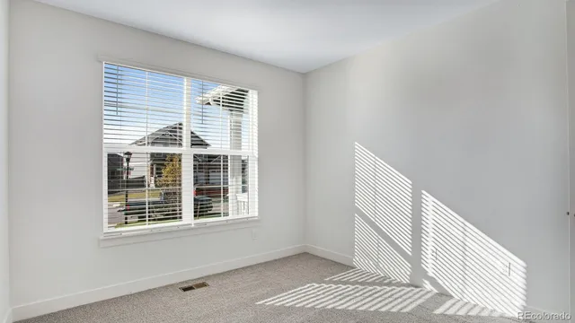 a view of wooden floor and windows in a room
