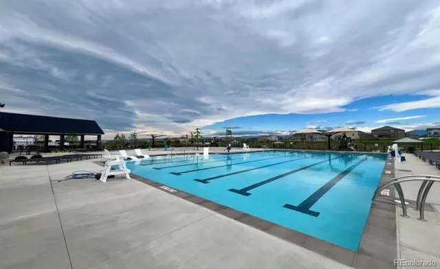 a view of swimming pool with seating area and furniture