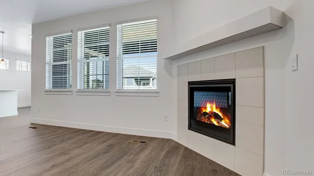 an outdoor living room with windows and fireplace