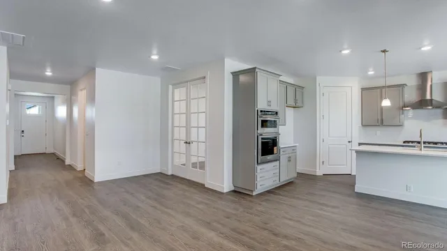 a view of kitchen with wooden floor and electronic appliances