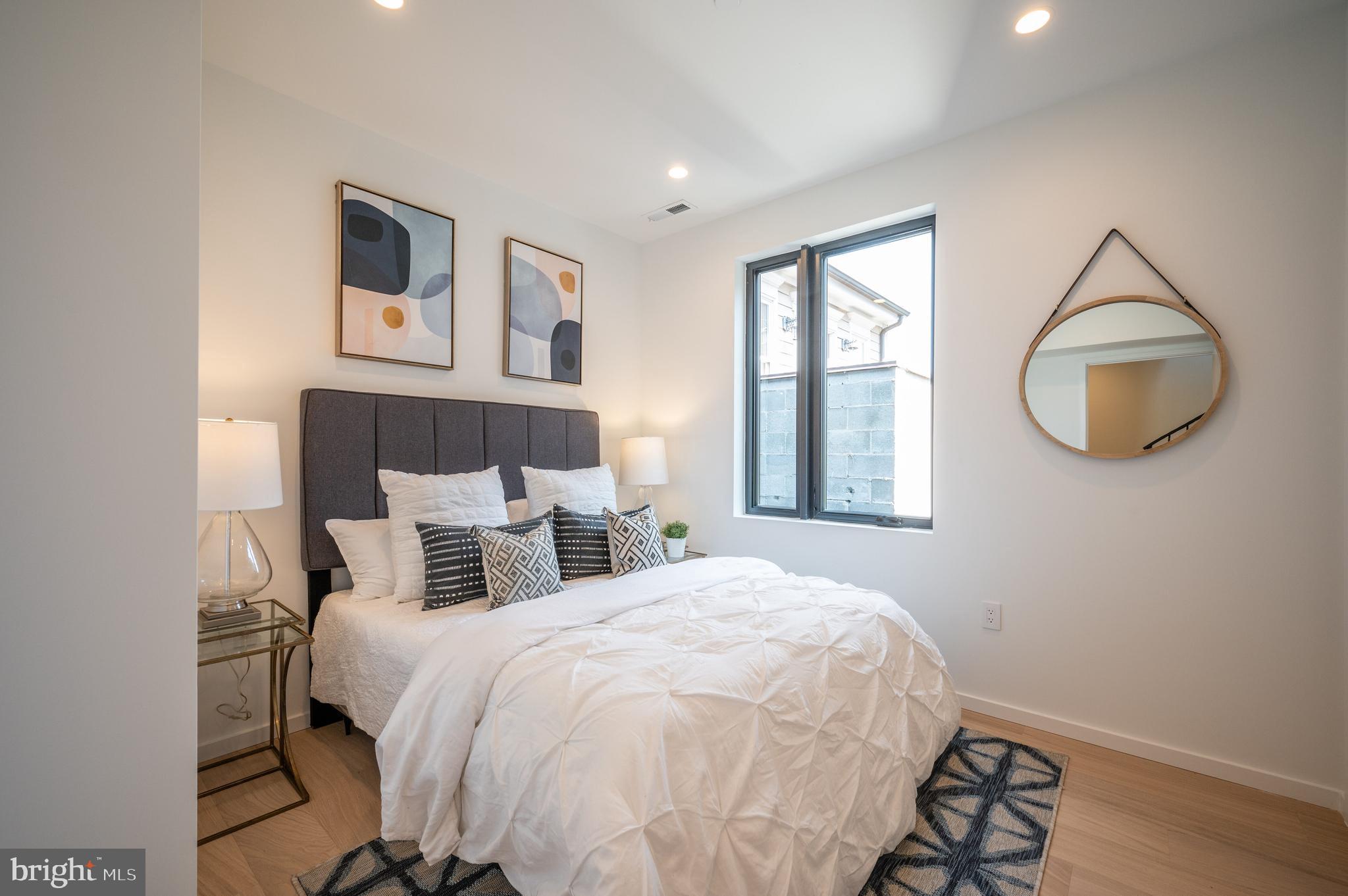 424 M Street Northwest, Unit 8 Washington, DC 20001 - Photo 18 of 27 a bedroom with a bed and wooden floor