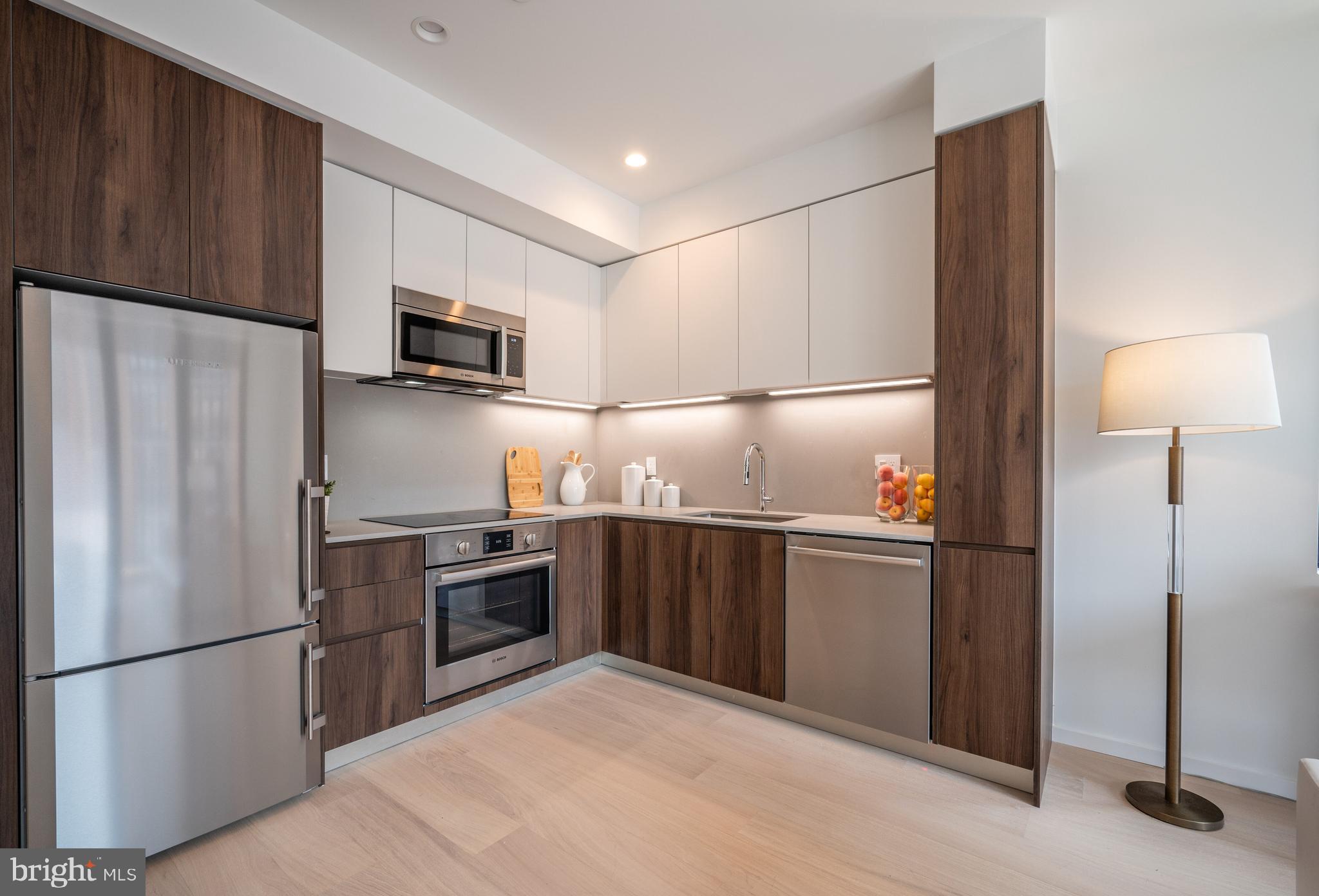 424 M Street Northwest, Unit 8 Washington, DC 20001 - Photo 8 of 27 a kitchen with stainless steel appliances granite countertop a refrigerator sink and microwave