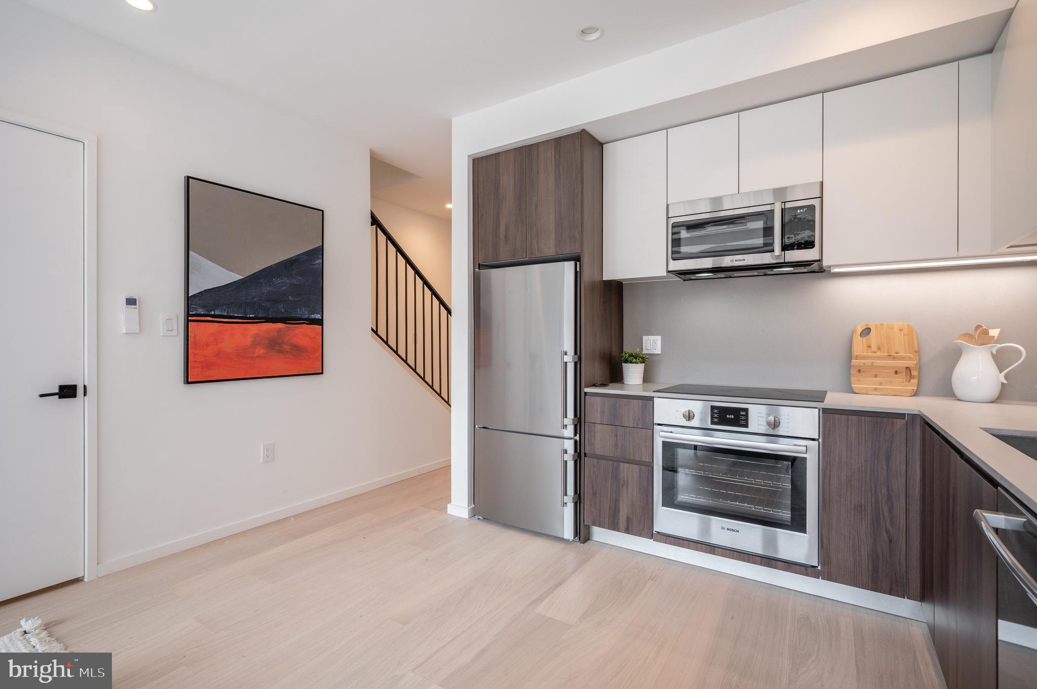 424 M Street Northwest, Unit 8 Washington, DC 20001 - Photo 9 of 27 a kitchen with stainless steel appliances granite countertop a refrigerator and a stove top oven