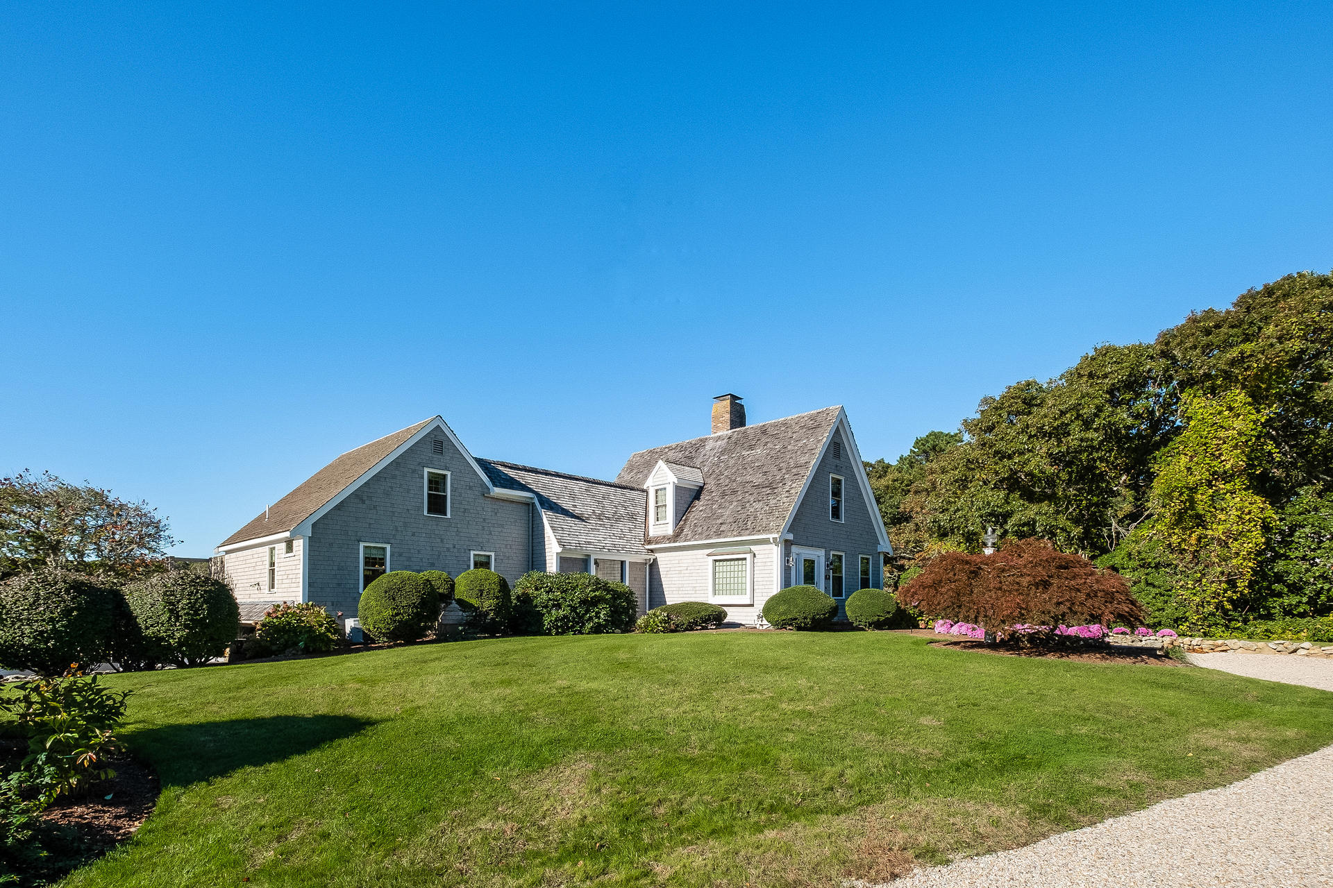 59 Bay Lane Centerville, MA 02632 - Photo 2 of 35 a view of a big house with a big yard and large trees