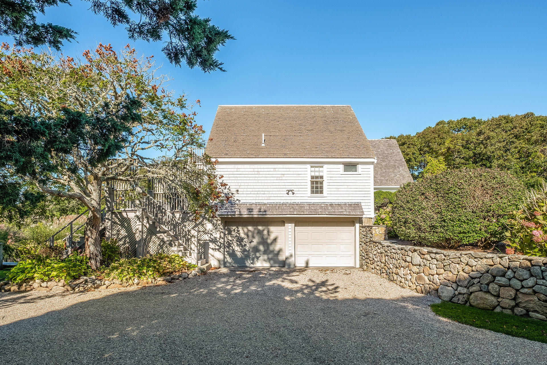 59 Bay Lane Centerville, MA 02632 - Photo 24 of 35 a front view of a house with a yard and garage