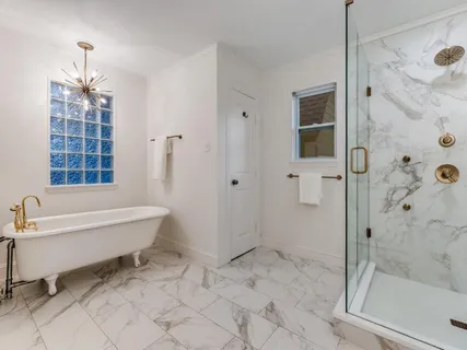 a bathroom with a bathtub and a shower