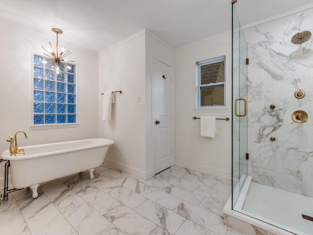 5514 Monticello Avenue Dallas, TX 75206 - Photo 12 of 20 a bathroom with a bathtub and a shower