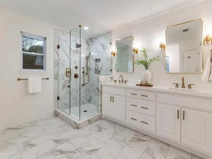 a spacious bathroom with a shower sink and mirror