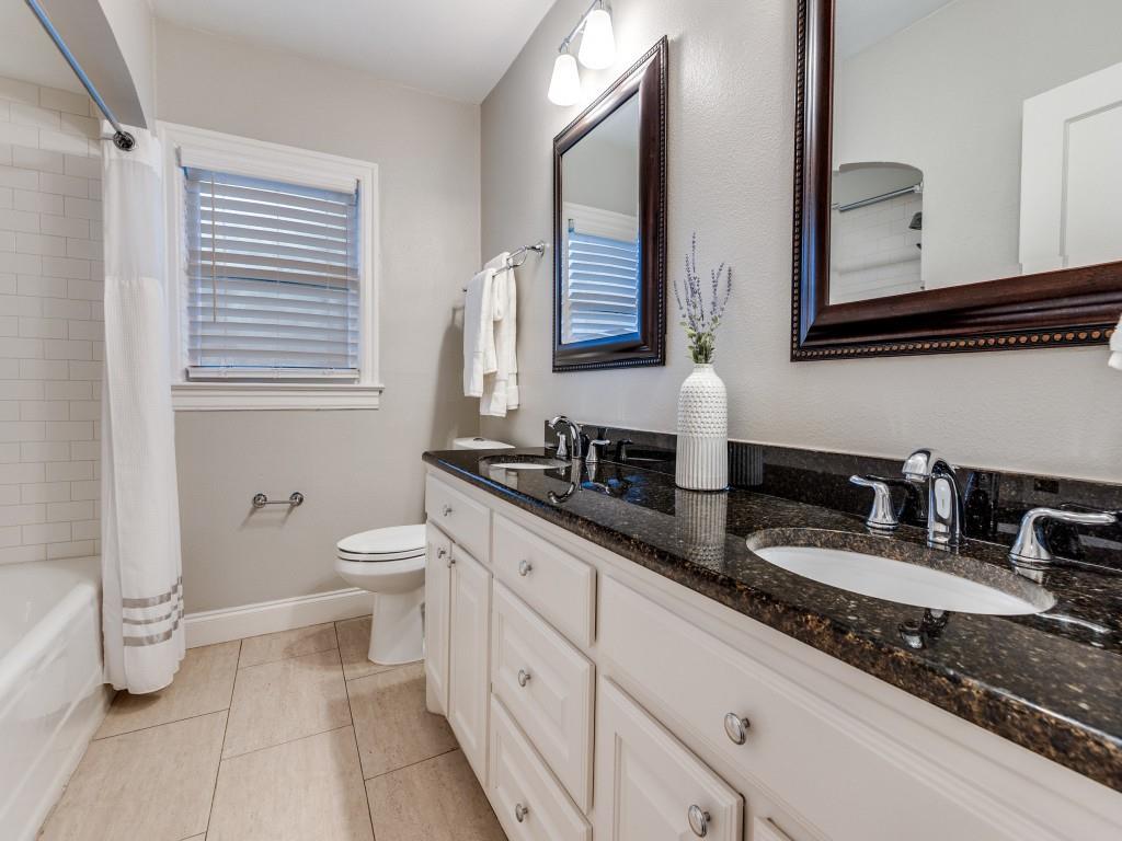 5514 Monticello Avenue Dallas, TX 75206 - Photo 15 of 20 a bathroom with double vanity and a mirror