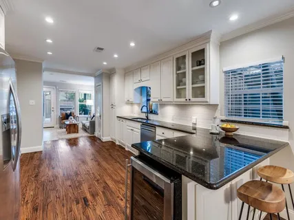 an open kitchen with sink and cabinets