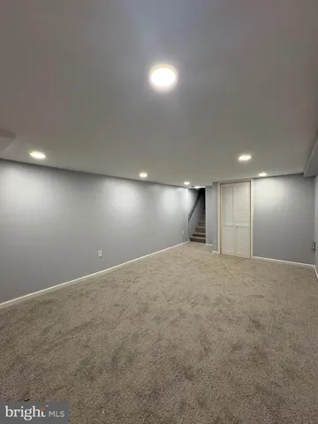 a view of a room with wooden floor and window