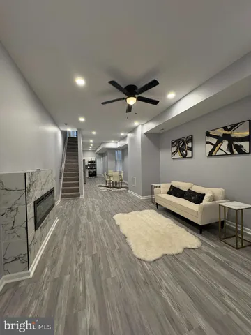 a living room with couch and a wooden floor