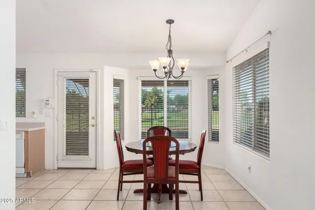 a view of a dining room with furniture wooden floor and chandelier