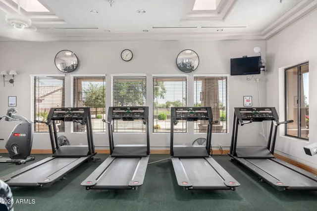 a room with gym equipment and large window