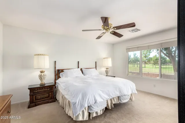 a bedroom with a bed and a large window