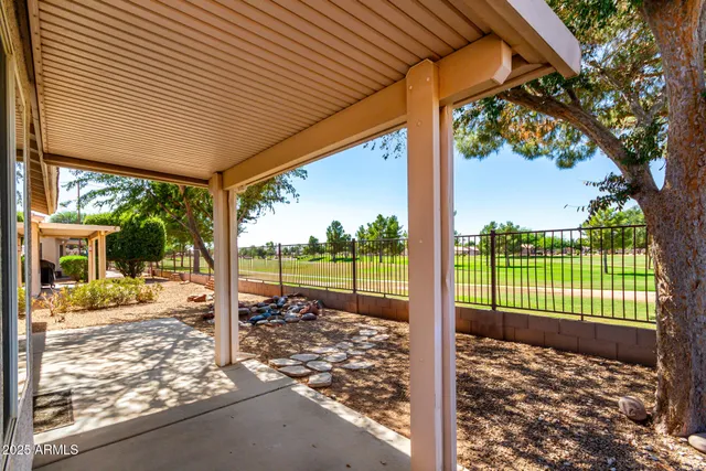 a view of a room with a floor to ceiling window next to a yard