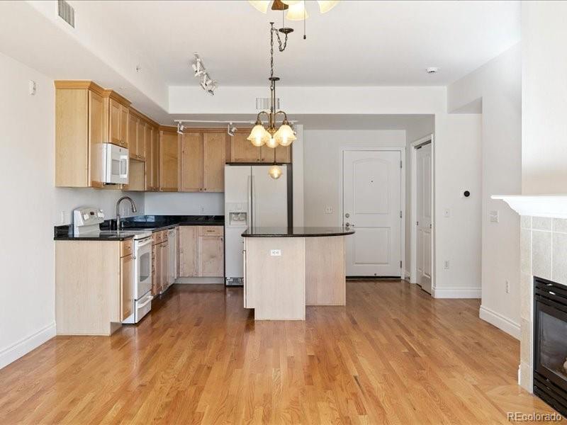 660 11th Street, Unit 104 Golden, CO 80401 - Photo 8 of 46 a kitchen with sink cabinets and wooden floor