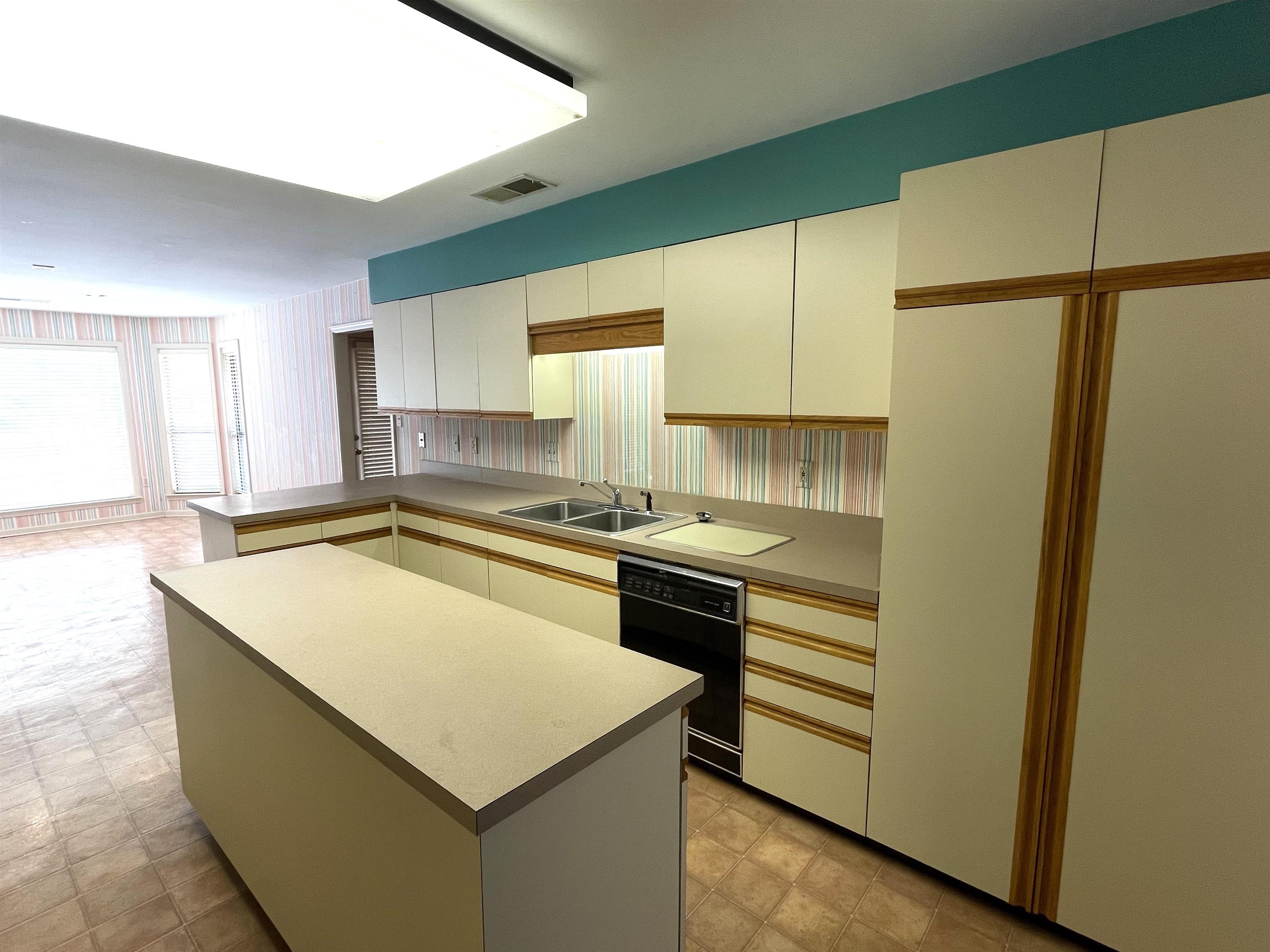 6588 Finch Road Memphis, TN 38141 - Photo 6 of 25 a kitchen with a stove a sink and a refrigerator