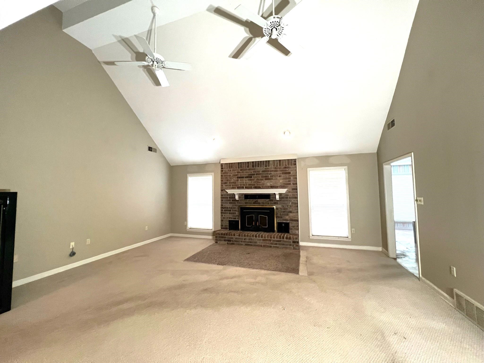6588 Finch Road Memphis, TN 38141 - Photo 7 of 25 an empty room with windows and fireplace