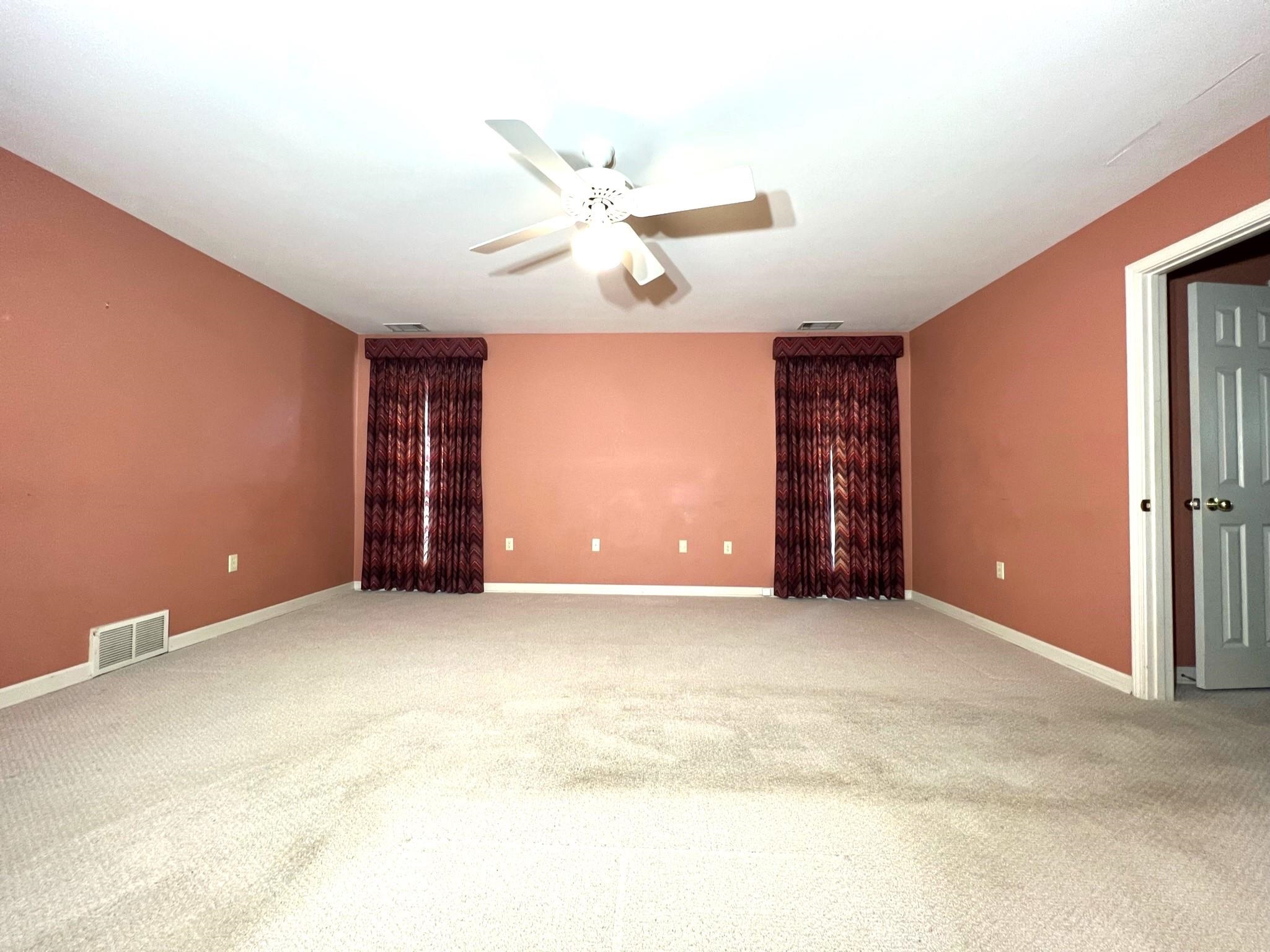 6588 Finch Road Memphis, TN 38141 - Photo 9 of 25 an empty room with chandelier fan and windows