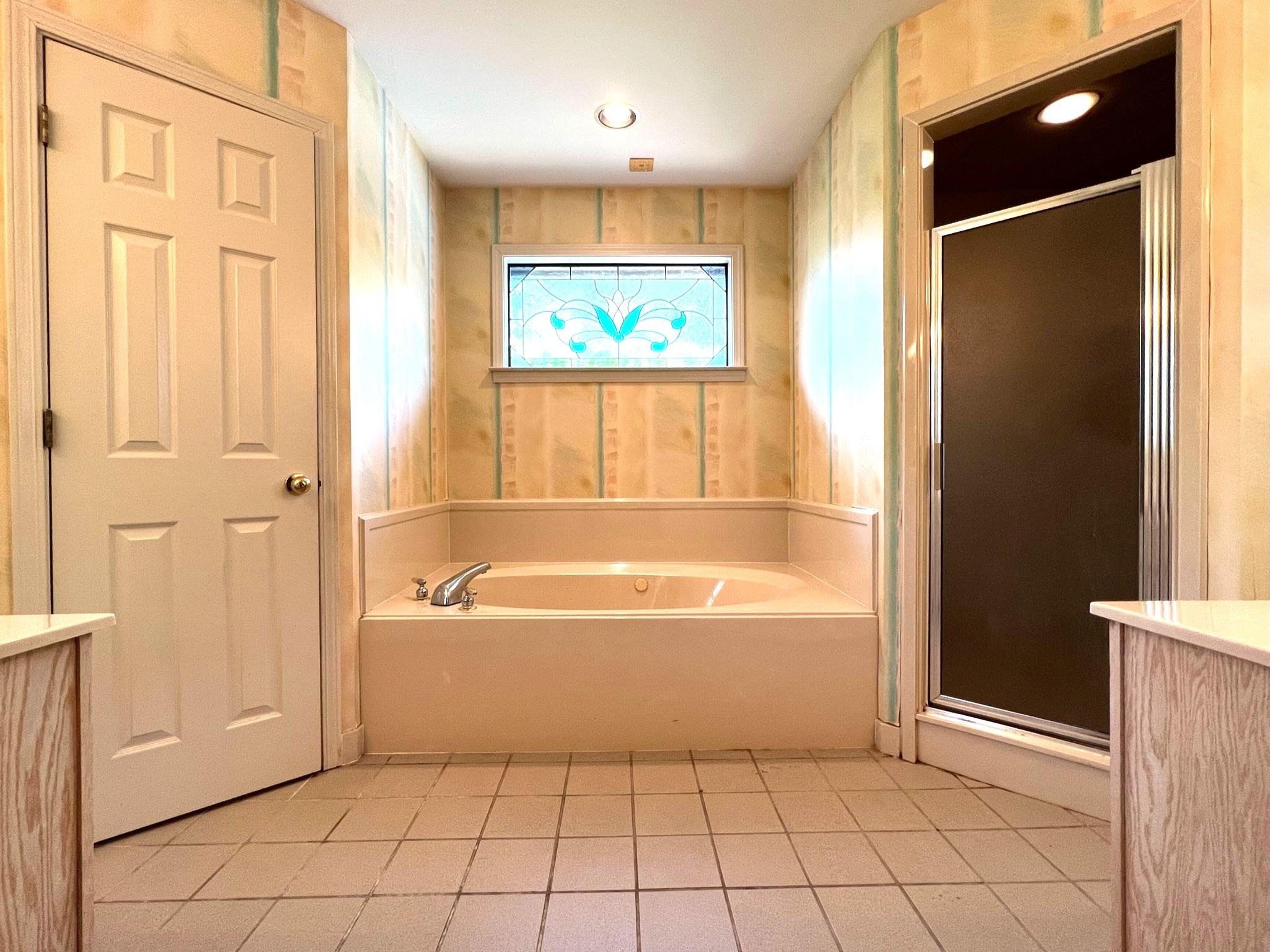 6588 Finch Road Memphis, TN 38141 - Photo 10 of 25 a bathroom with a bathtub and a shower