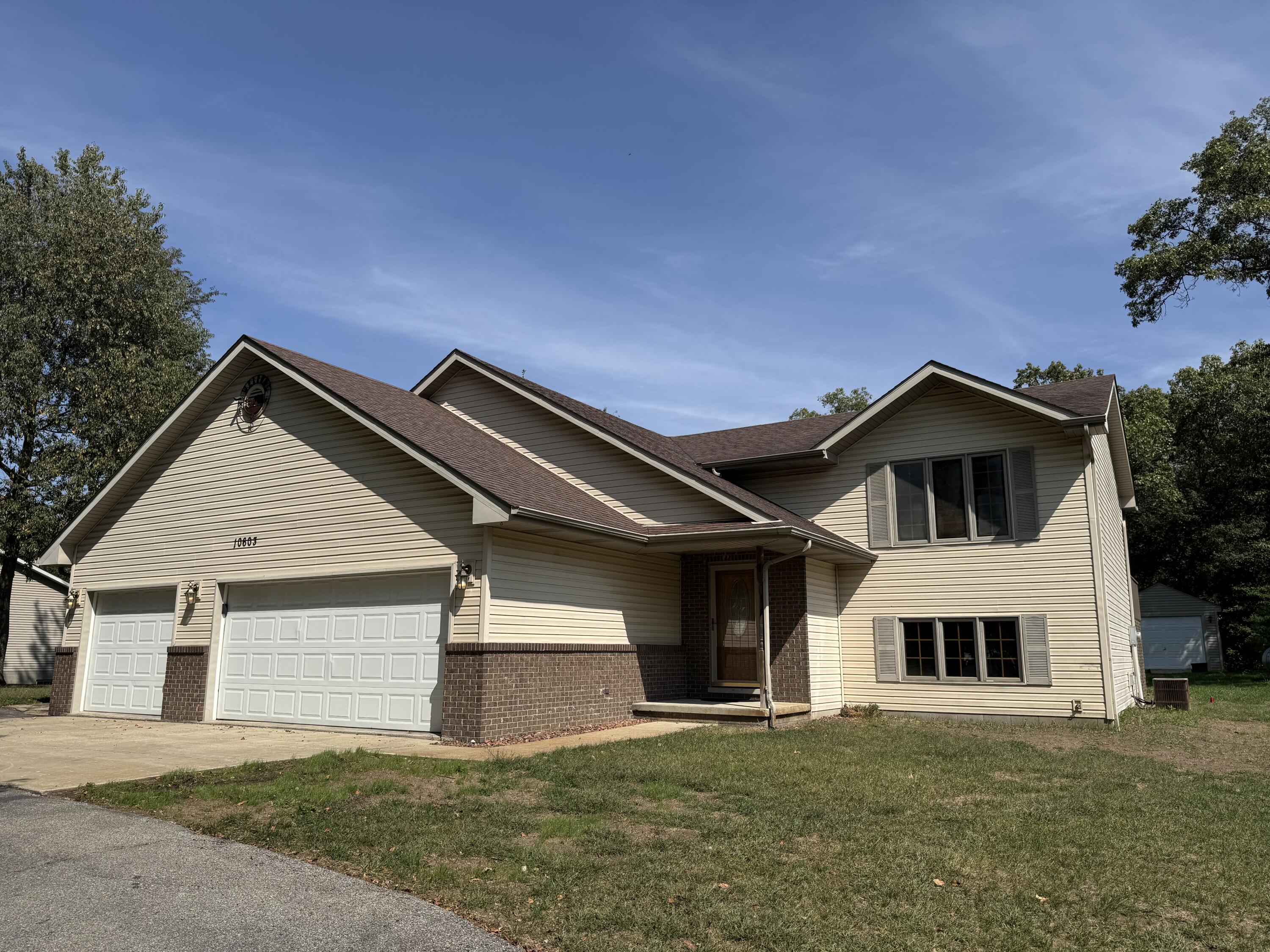 a front view of a house with a yard and garage