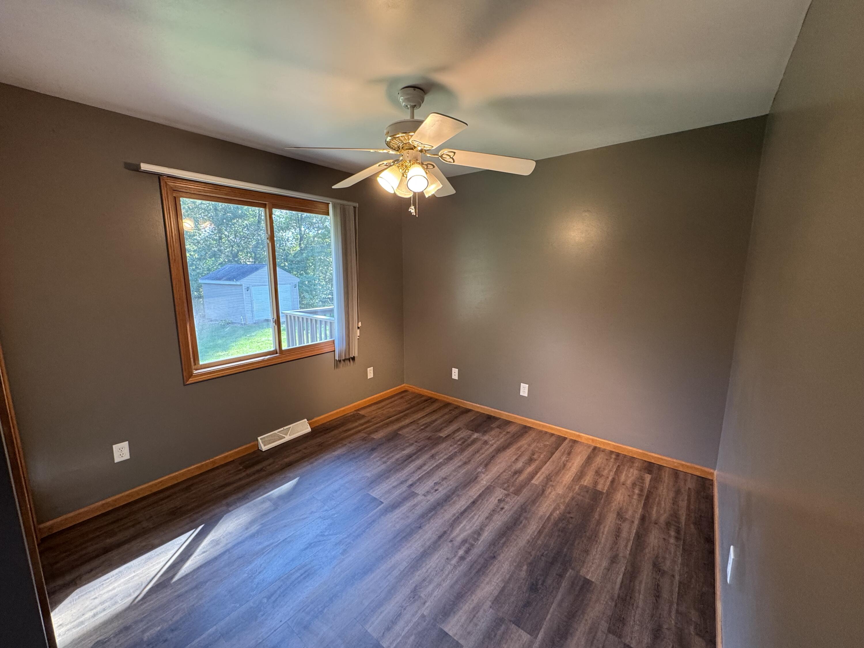 10603 Georgetown Drive Demotte, IN 46310 - Photo 12 of 31 a view of room with window ceiling fan and hardwood floor
