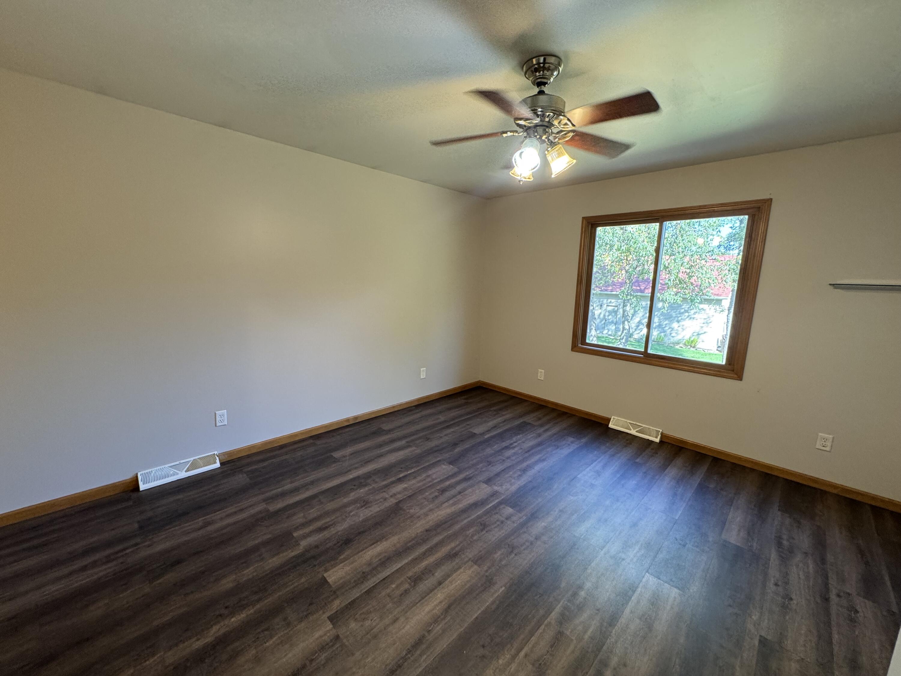 10603 Georgetown Drive Demotte, IN 46310 - Photo 14 of 31 a view of an empty room with wooden floor and a window