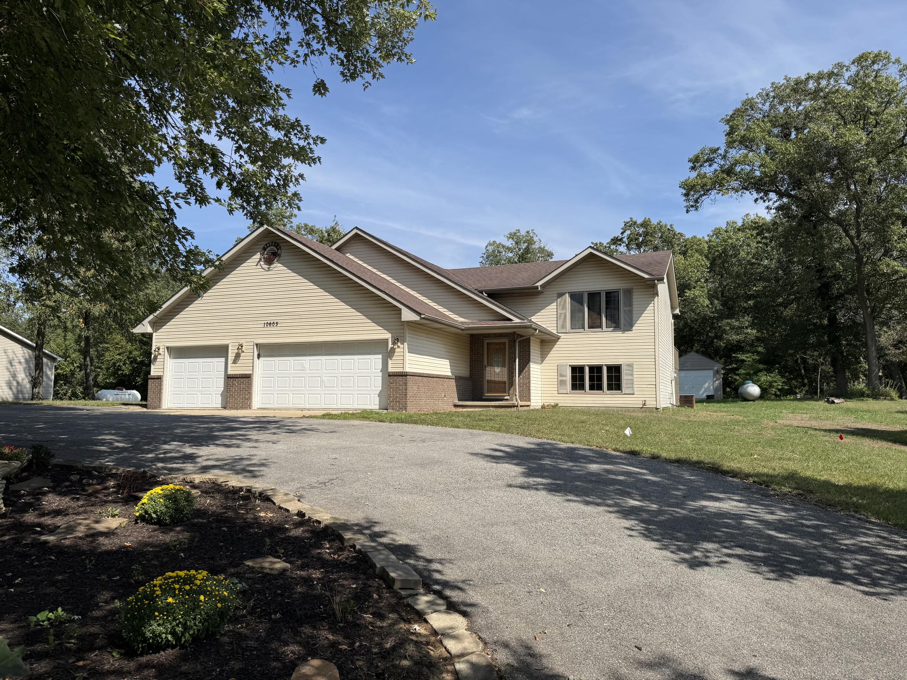 10603 Georgetown Drive Demotte, IN 46310 - Photo 2 of 31 a front view of a house with a yard and garage