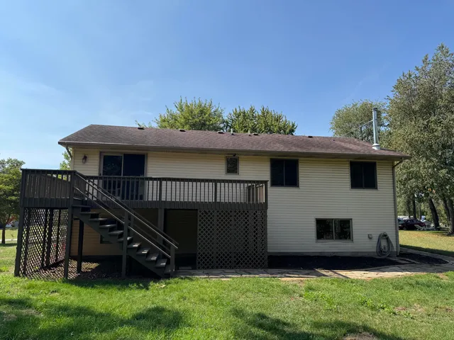 a view of a house with a yard and sitting area