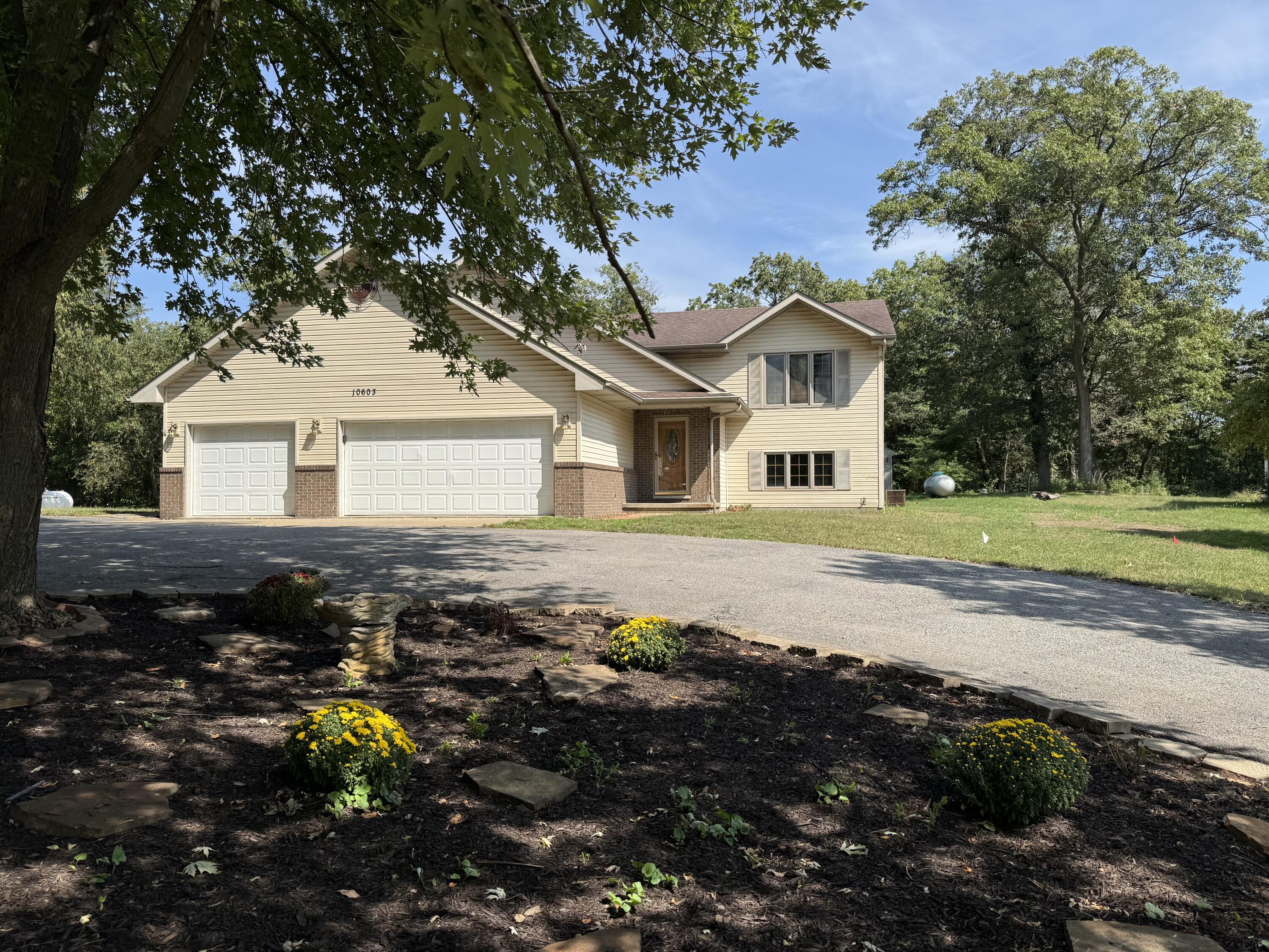 10603 Georgetown Drive Demotte, IN 46310 - Photo 3 of 31 a front view of a house with a garden
