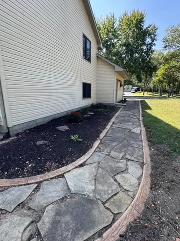a view of a backyard with large trees