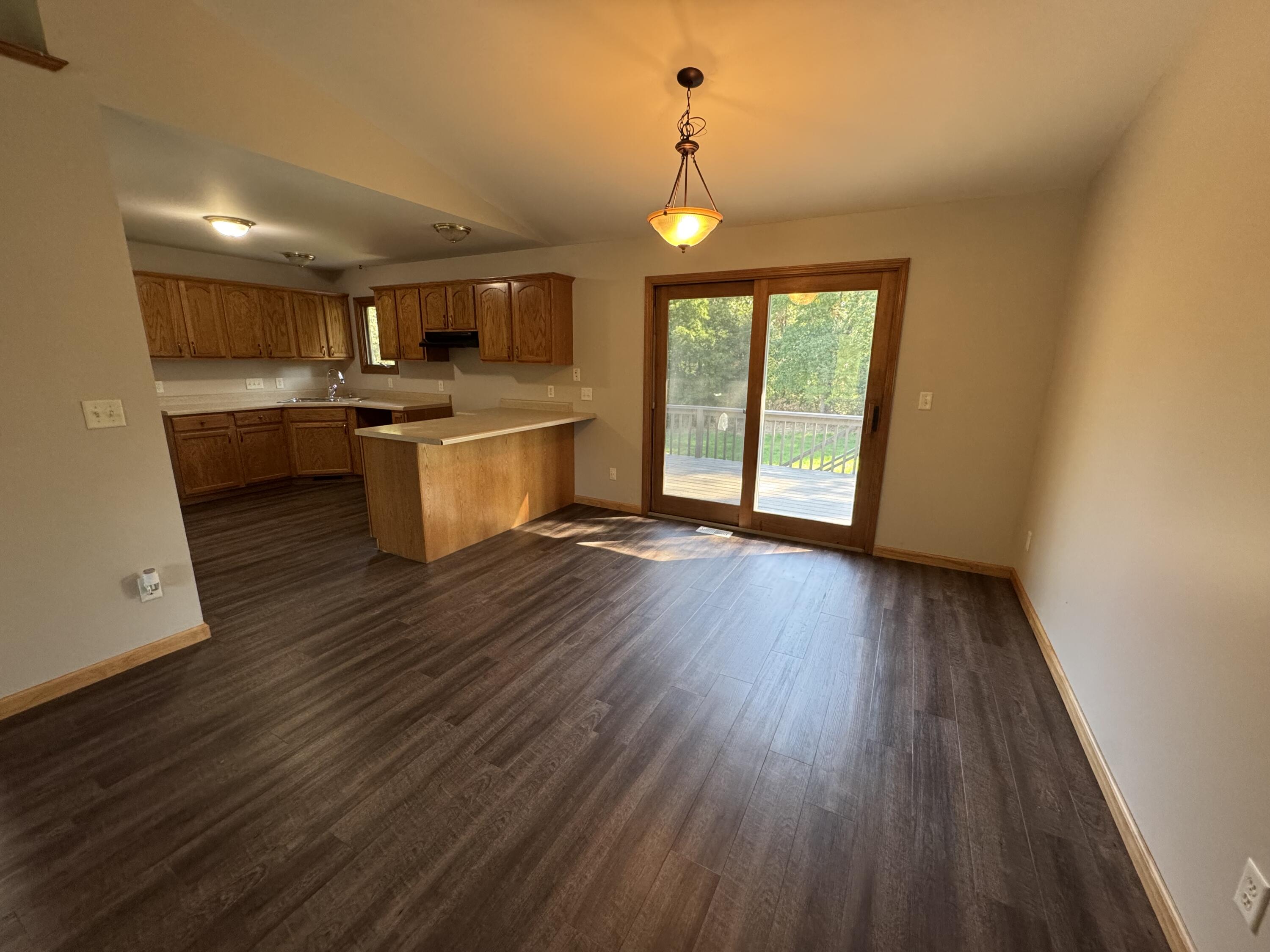 10603 Georgetown Drive Demotte, IN 46310 - Photo 7 of 31 a kitchen with counter top space stainless steel appliances and wooden floor