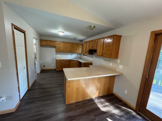 a room with wooden floor and furniture