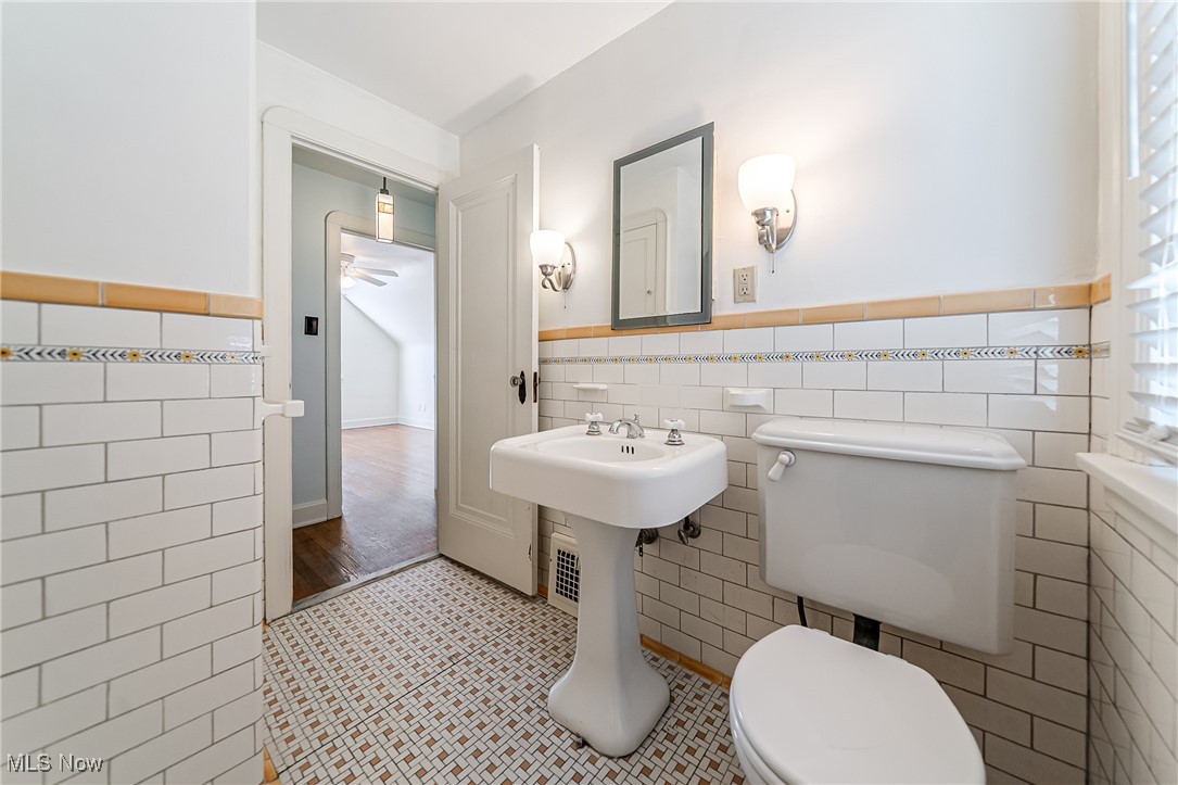 6711 Forest Avenue Parma, OH 44129 - Photo 24 of 33 Bathroom featuring tile walls, tile patterned flooring, and wainscoting