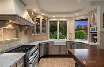 a kitchen with stainless steel appliances granite countertop a sink counter space cabinets and living room view