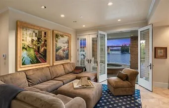 a view of a city with flower plants and wooden fence