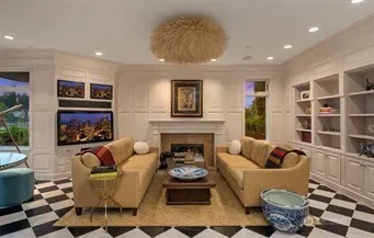 a living room with furniture a rug and a flat screen tv