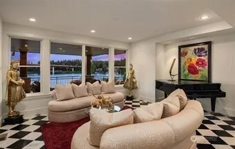 a living room with furniture a fireplace and floor to ceiling window