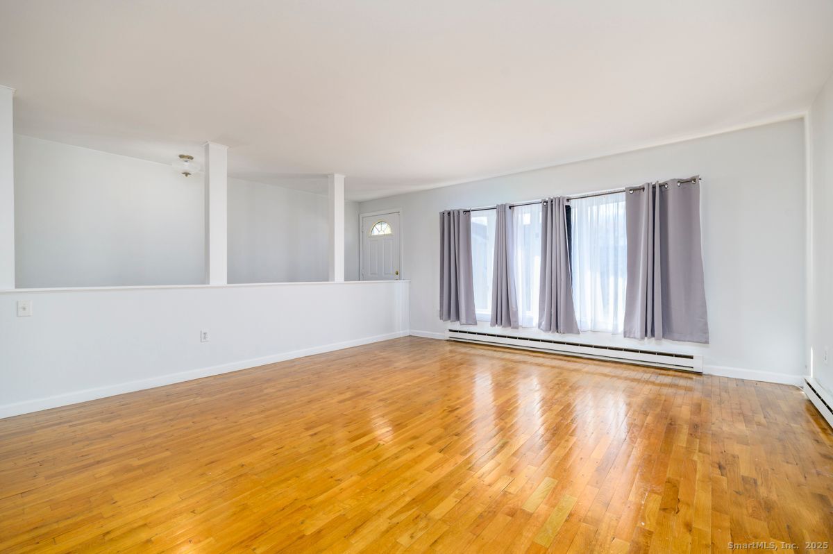 200 Frederick Street, Unit 2 Stamford, CT 06902 - Photo 2 of 13 a view of an empty room with wooden floor and a window