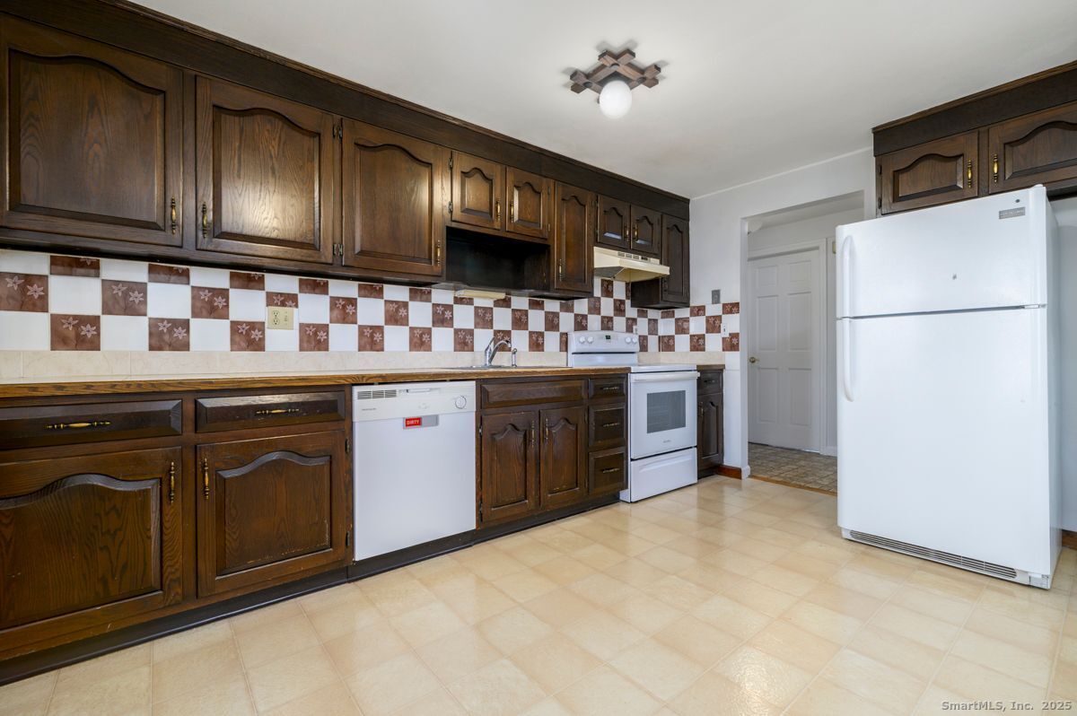 200 Frederick Street, Unit 2 Stamford, CT 06902 - Photo 5 of 13 a kitchen with stainless steel appliances granite countertop a stove refrigerator and cabinets