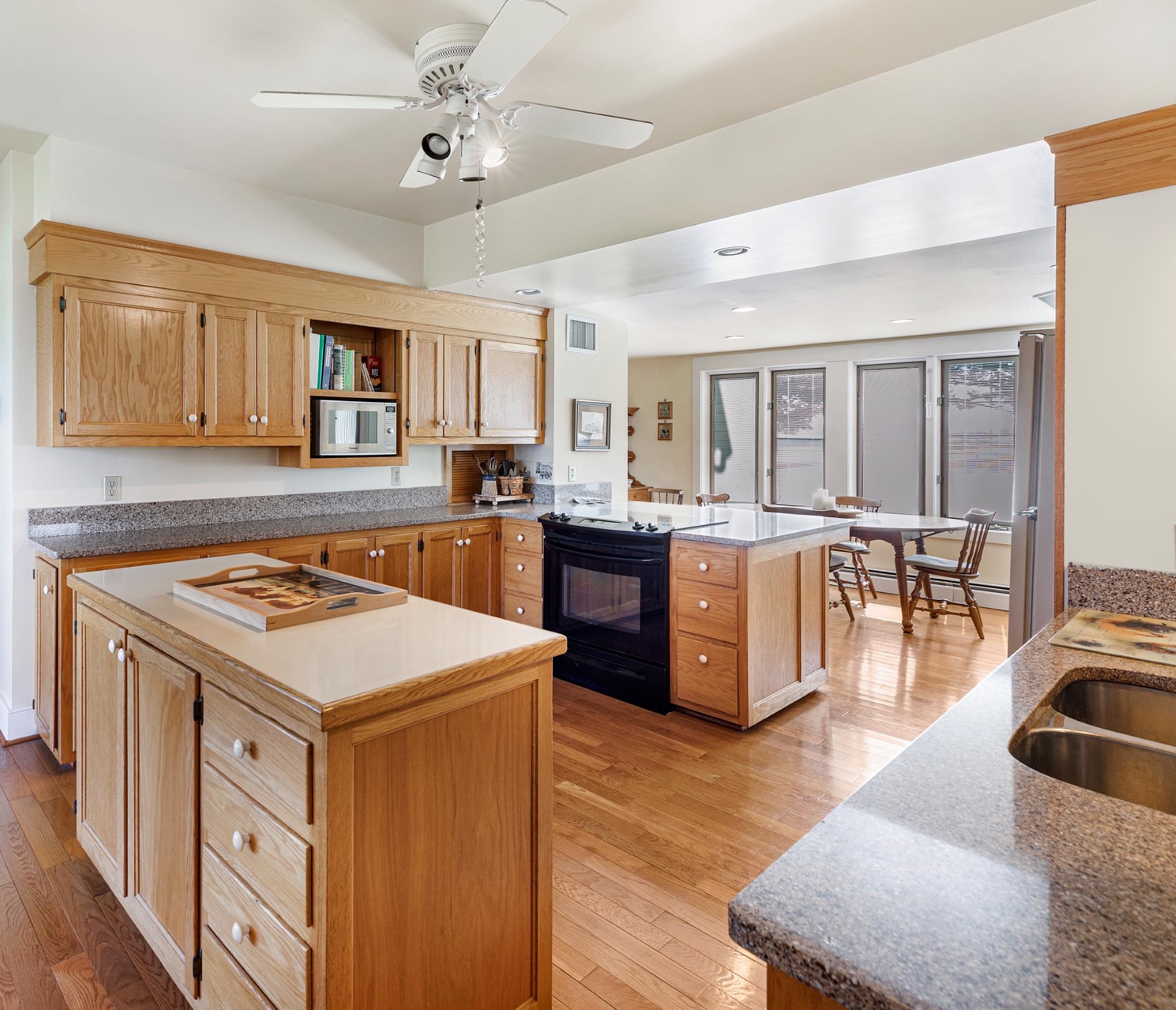 191 Middle River Road Staunton, VA 24401 - Photo 12 of 55 a kitchen with kitchen island a stove a sink a dining table and chairs with wooden floor