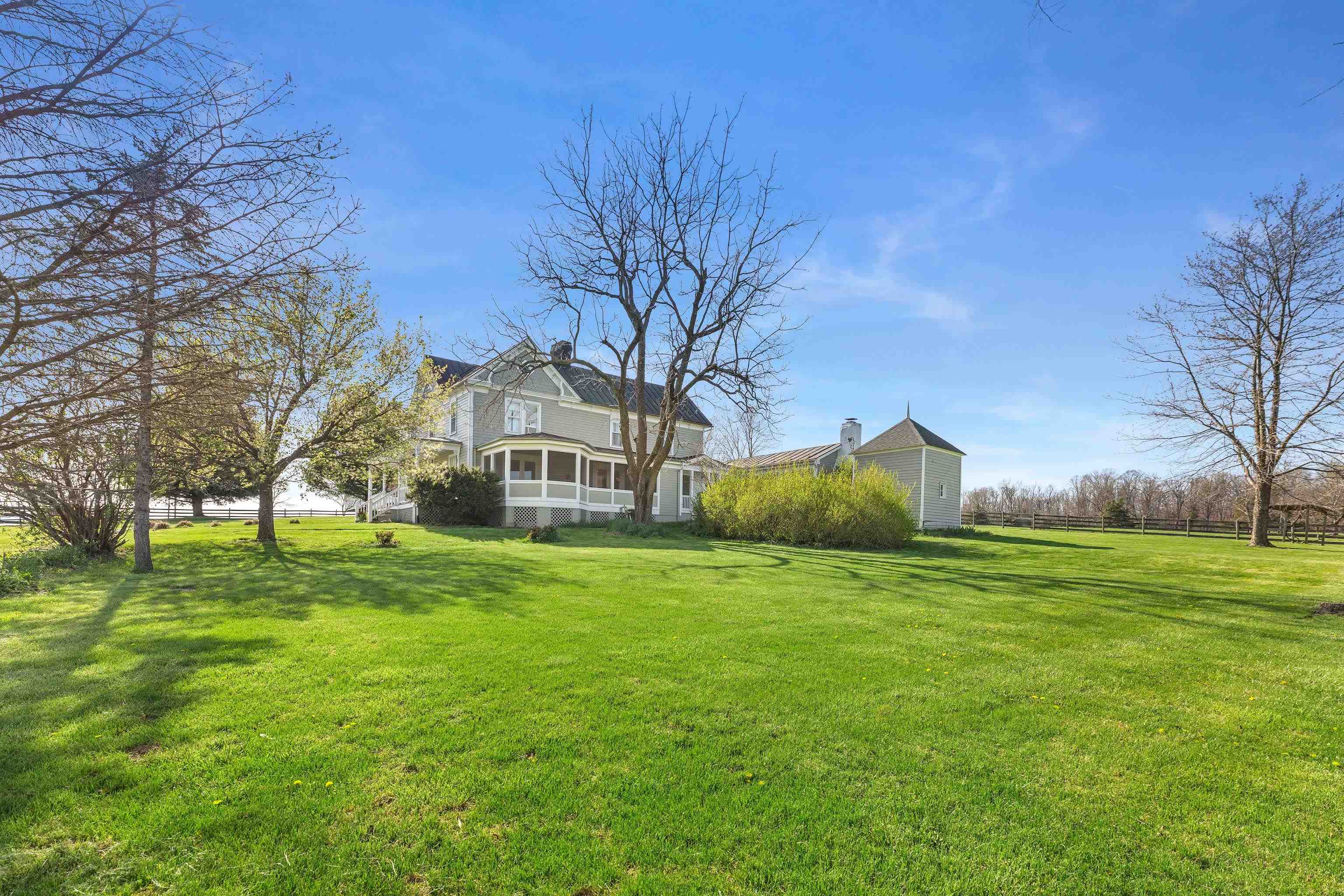 191 Middle River Road Staunton, VA 24401 - Photo 5 of 55 a view of a big house with a big yard and large trees