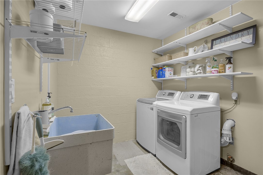 218 Northridge Drive Anderson, SC 29621 - Photo 20 of 50 Functional laundry space featuring a utility sink and convenient shelving for supplies.