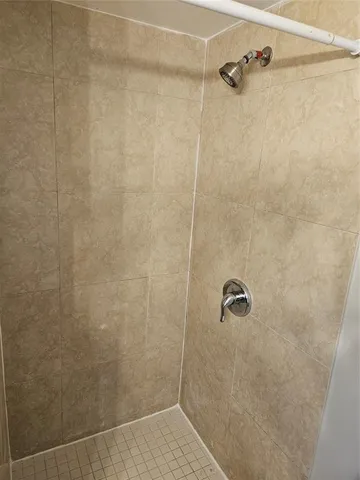 a bathroom with a sink a mirror and shower
