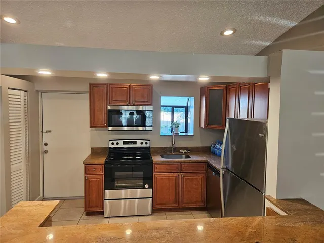 a kitchen with a refrigerator stove and a sink